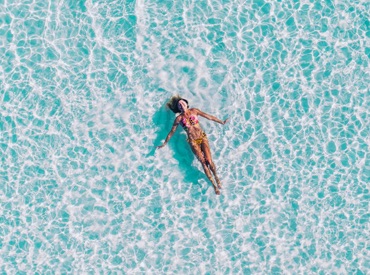 lady floating in the clear sea